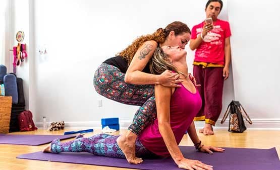 Teacher giving a hands-on adjustment to a student